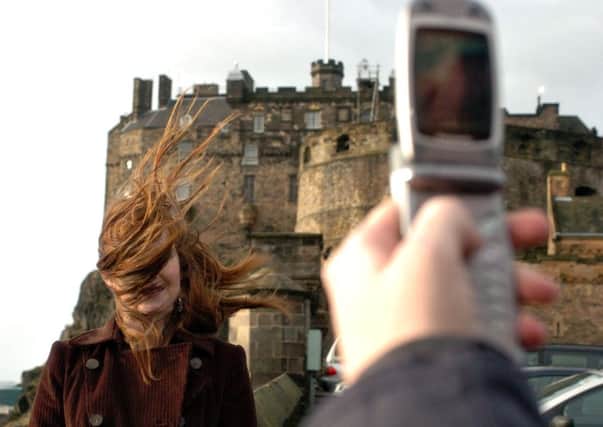 Tourists query why the Capital is so windy. Picture: Toby Williams