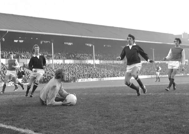 Kevin Hegarty, who scored for Hearts, left, and Donald Ford home in on the Hibs goalkeeper in 1971