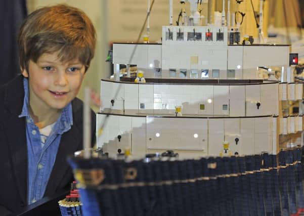 Henry Hussain, 8, has a close look at the lego model. Picture: Neil Hanna