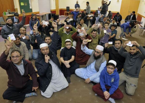 Members of the Muslim Forum destroy their SNP membership cards after comments by Kenny MacAskill. Picture: TSPL
