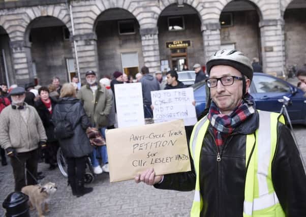 Peter Gregson hands over a petition opposing the plans at City Chambers. Picture: Greg Macvean