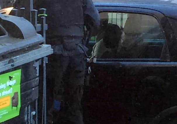 The photo shows an armed police officer carrying out a routine traffic stop. Picture: Iain McGill/Twitter