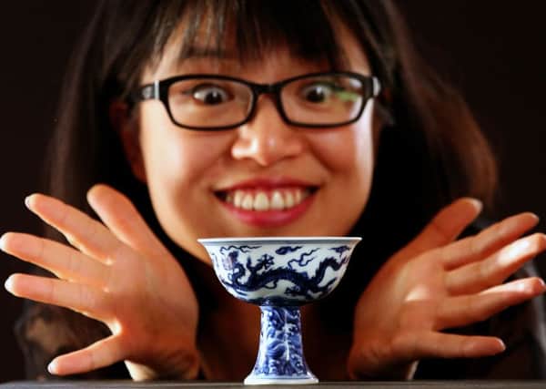 Asian specialist Ling Zhu from Lyon and Turnbull Auctioneers  with the Stem Cup. Picture: PA