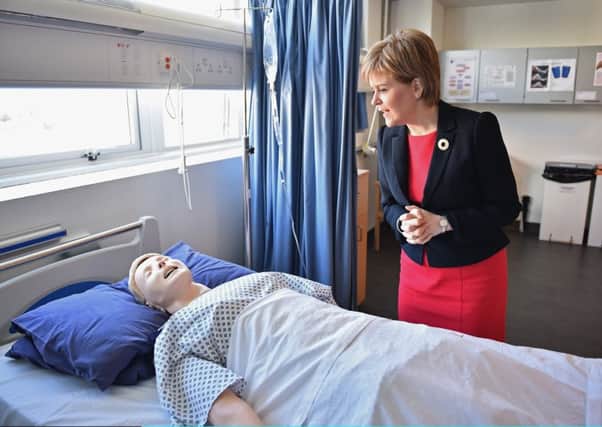Nicola Sturgeon observes a human training dummy as she meets with students at a mock hospital ward at Queen Margaret University. Picture: Jeff J Mitchell/Getty Images