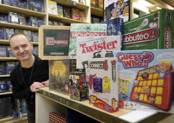 Blackwells Bookshop floor manager Calum McGhie with some of the board games the store sells. Picture: Jane Barlow