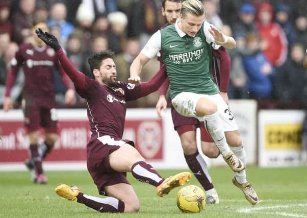 Miguel Pallardo of Hearts and Jason Cummings of Hibs battle for the ball. Picture: Greg Macvean