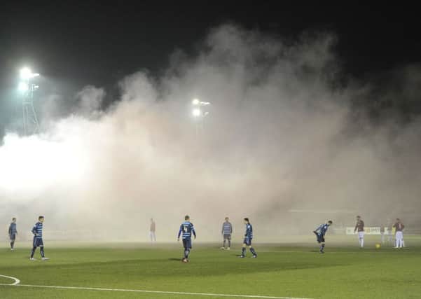 The game was delayed after a flare was thrown. Picture: Ian Rutherford