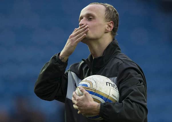 Leigh Griffiths celebrates with the match ball at the end of the game