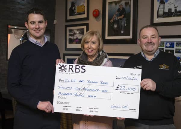 Linda Simpson accepts a cheque from Ed Hodge, left, and Kingsfield captain Ian Fowler