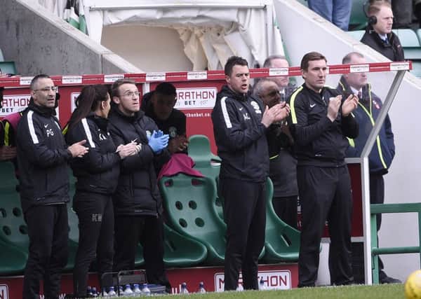 The Hibs bench joined in the minute's applause. Pic: Greg Macvean