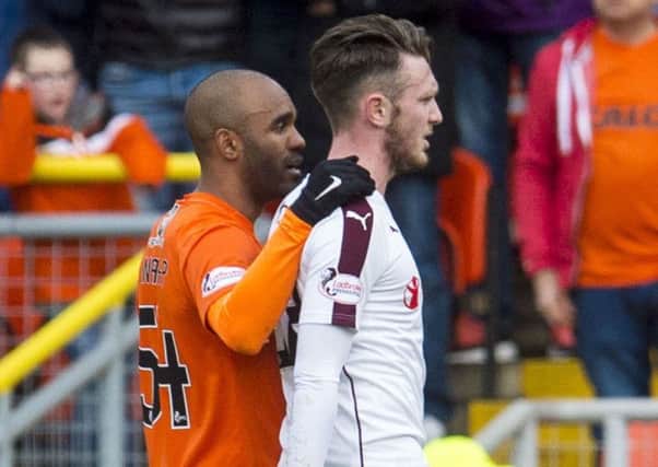 Dundee United's Florent Sinama-Pongolle consoles Hearts' Jordan McGhee after was sent off