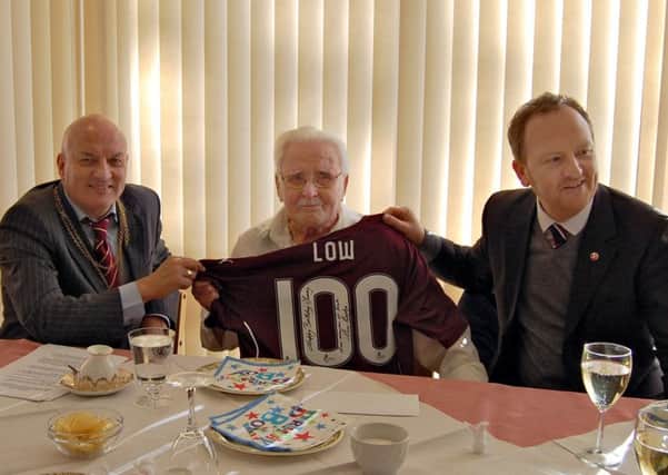 Tommy Low - 100 year old at his celebration party with Steve Cardownie, left, and  Scot Gardiner, Chief Operating Officer at Hearts FC.
 
He gave Tommy the shirt o behalf of the Club, signed on the back and printed with his surname LOW and player number 100. Tommy will feature in the Hearts programme against Inverness tomorrow night.

Tommy will be 100 years old on Monday 22nd February 2016, and a celebration party will be held with residents and friends in the lounge of the Bields Home where he lives in Corstorphine. He will receive the traditional Queens greeting and it will be presented by the Deputy Lord Provost of Edinburgh, Steve Cardownie.