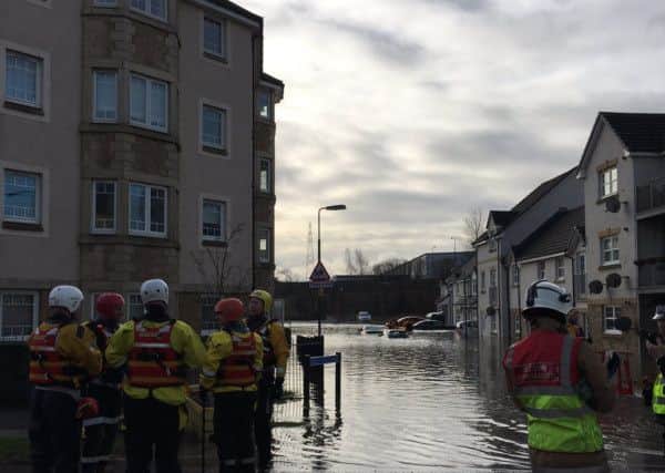 Emergency services teams at the scene of the flooding. Picture: Shaun Milne