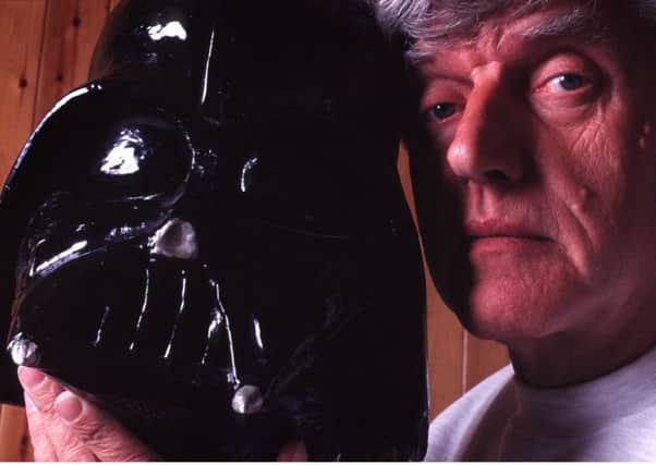 Dave Prowse with the mask he wore when he played Darth Vader