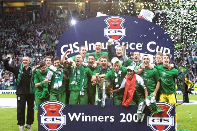 The Hibs team line up with the League Cup trophy. Pic: SNS