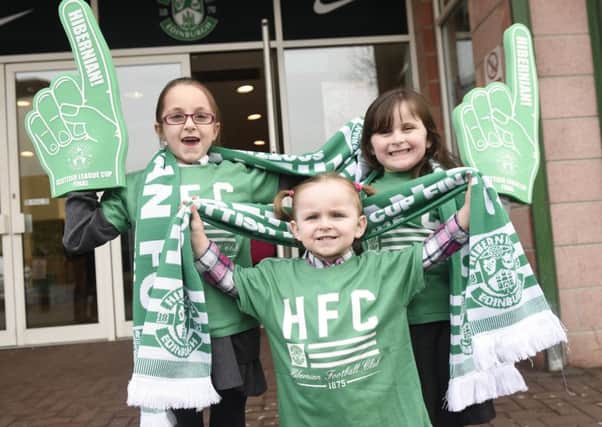Connie, 7, Shania, 3, and Zara Stenhouse, 5, get geared up for Hampden. Picture: Greg Macvean