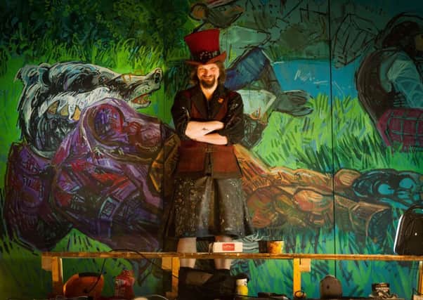 Chris Rutterford with his Wind in the Willows mural at the Tron Kirk. Picture: Scott Taylor