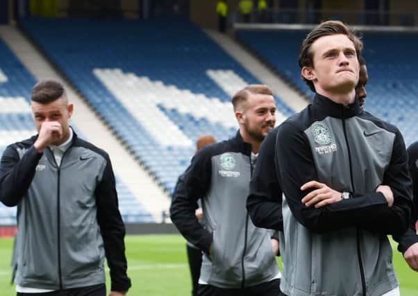 Danny Handling, second left, walks the Hampden pitch with team-mates