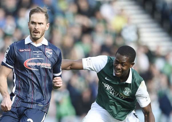 Marvin Bartley battles with Ross Countys Martin Woods at Hampden on Sunday. Picture: Greg Macvean