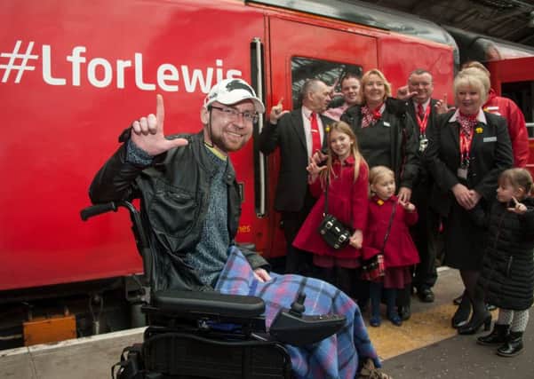 Lewis Vaughan poses with supporters as the train with #LForLewis arrives at Waverley Station. Picture: Andrew O'Brien
