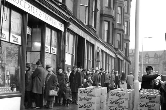 Customers queue outside Mr Munro's shop at Brandon Terrace in Edinburgh stocking up for Hogmanay