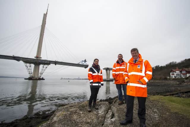 Keith Brown pictured with Jared Carlson and Jennifer Bullingham, engineers who have worked on the launch of the Queensferry Crossing's north approach viaduct, successfully launched earlier this month. Picture: Transport Scotland