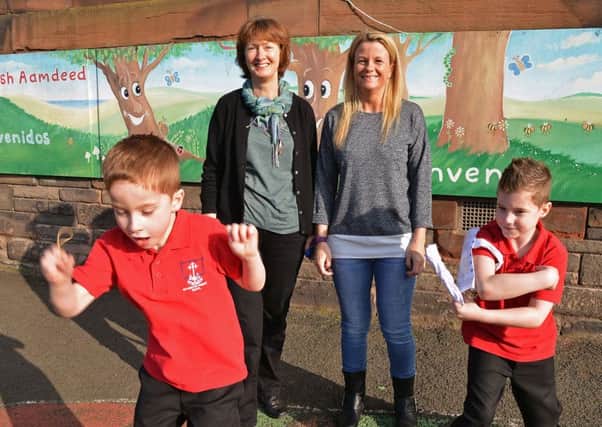 Speech therapist Hilary Cowie with Paula McLear and her sons Aiden and Kian. Picture Jon Savage