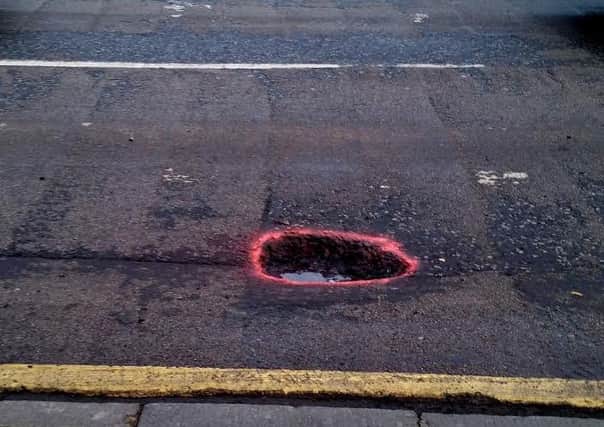 Gerry Farrell has spray painted rings around potholes to help other drivers.