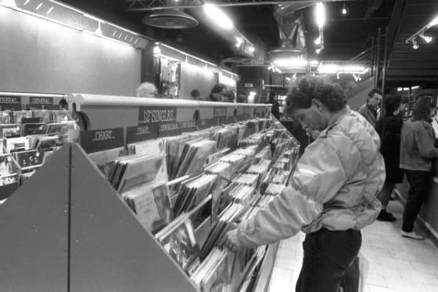 The Other Record Shop moved from the High Street to Princes Street in Edinburgh in December 1985. A man browses the 12" singles.