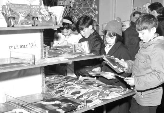 Children buying records from Blyth's in Earl Grey Street, Edinburgh during its winter sale