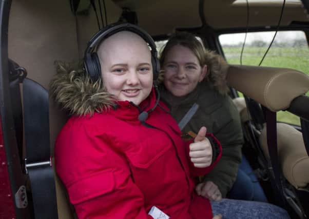 Megan Fletcher and her mother Shona in  Sandy Bloomer's helicopter. Picture: Ian Rutherford