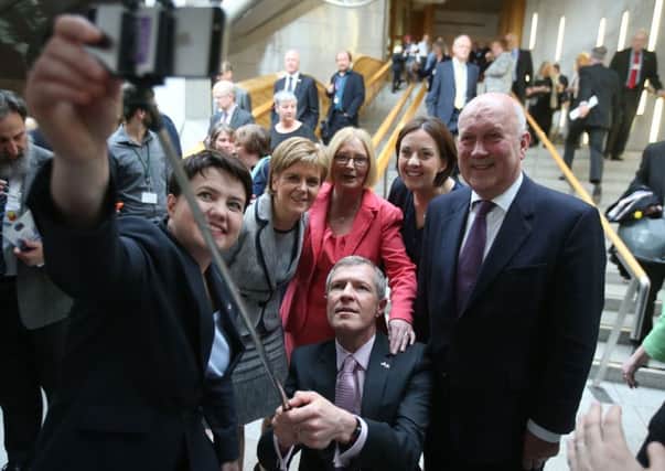 Lib Dem leader Willie Rennie wields the selfie stick as Ruth Davidson, Nicola Sturgeon, Tiricia Marwick, Kezia Dugdale and John Scott pose for a picture. Picture: Andrew Milligan/PA Wire