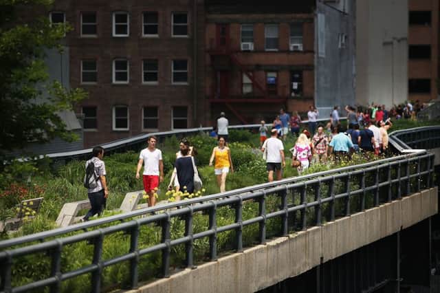 Visitors walk along the New York High Line in 2013. The park was built on a former elevated goods railway. Picture: Getty