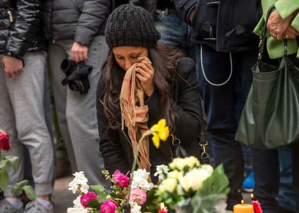 A woman reacts during a minute of silence held at a makeshift memorial in front of Brussel's Stock Exchange on Place de la Bourse (Beursplein). Picture: AFP/Getty Images