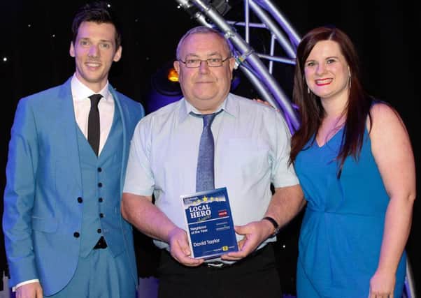 David Taylor receives last year's neighbour award from Claire McBlain and show host Scott Hoatson. Picture: Scott Louden