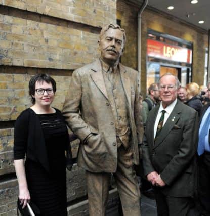 Sculptor Hazel Reeves stands next to her statue of the railway engineer, Sir Nigel Gresley, with his grandson Tim Godfrey. Picture: Clive Gee/PA Wire