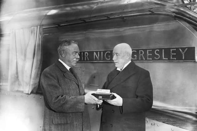 William Whitelaw presents railway engineer Sir Nigel Gresley with a silver model of the engine named after him, November 1937. Behind them is the actual locomotive, the 100th Pacific class loco to be built. Picture: Topical Press Agency/Hulton Archive/Getty Images