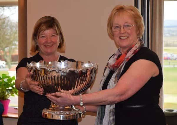 Nick Black, captain of Gullane Ladies Golf Club, receives the trophy from Whitekirk captain Janice MacLeod