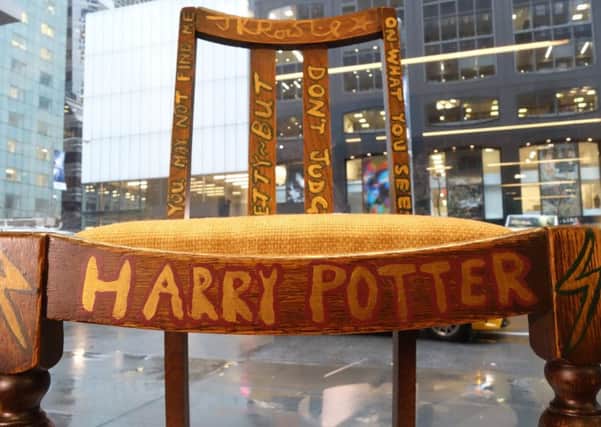 A chair used, and later decorated, by author J.K. Rowling while she wrote the first two Harry Potter books on display alongside a letter of provenance from the author at Heritage Auctions in New York on April 4 2016 ahead of its sale on April 6. Picture: William Edwards/AFP/Getty Images