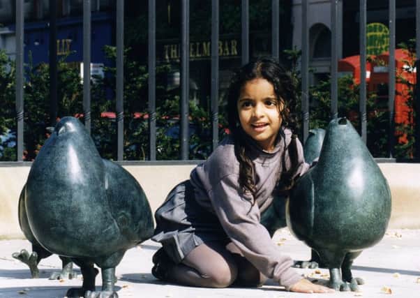 Munpreet Singh checks out the pigeons in situ on Leith Walk in 1997 . Picture: Graham Hamilton