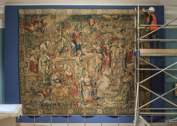 Assistant textile conservator Kate French installs the Triumph of Prudence tapestry in the Art of Living gallery. Picture: Phil Wilkinson