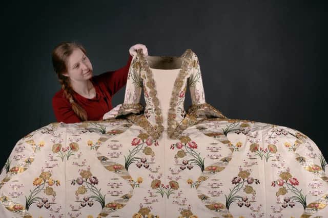 Costume mounting specialist Cecilia Voss puts the finishing touches to a womans court mantua from 1750-1770. Picture: Neil Hanna