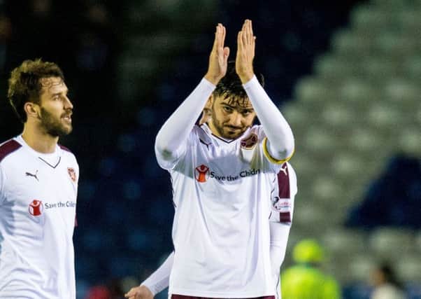 Hearts captain Alim Ozturk applauds the fans who made the trip to Inverness