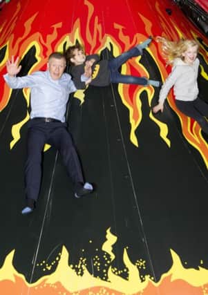 Scottish Lib Dem leader Willie Rennie tries out a volcano slide with children of his partys candidates. Picture: Katielee Arrowsmith/SWNS