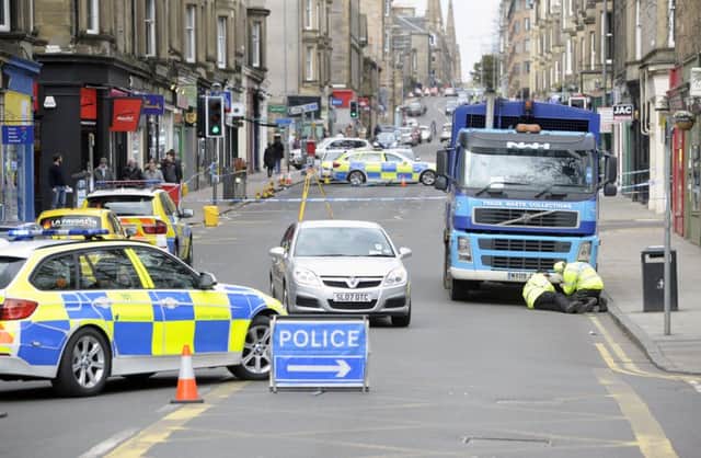 Police officers examine the bin lorry involved in the accident. Picture: 

 Neil Hanna