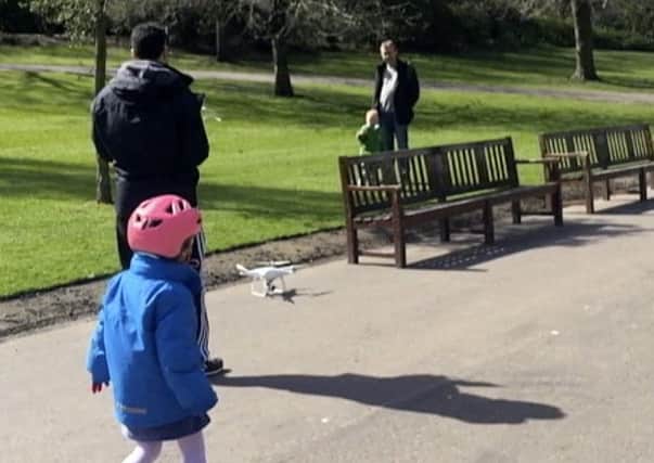 The man operating the drone in Princes St Gardens.