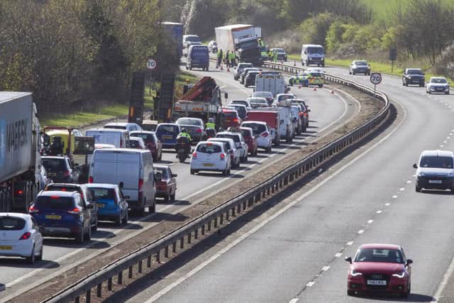 TNT lorry mounts the central reservation at Calder Junction of the Edinburgh City Bypass causing chaotic rush hour traffic. Pictures: SWNS