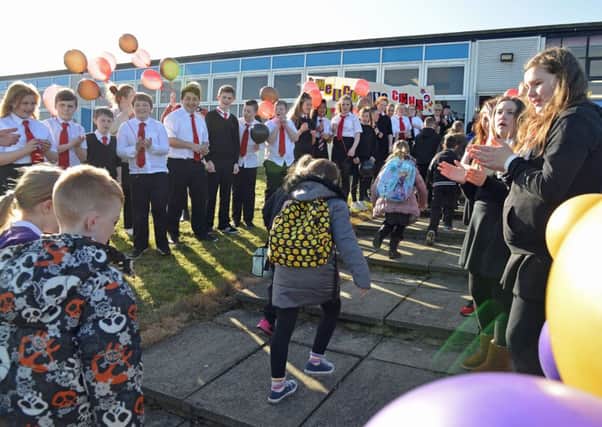 S1 and S2 pupils at Castlebrae welcome kids from Castleview Primary to their temporary home. Picture: Jon Savage