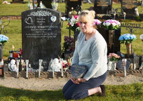 Grace Logan at her daughter's grave. Picture: Toby Williams