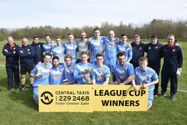The Spartans officials and playing squad show off their prize after beating Leith Athletic